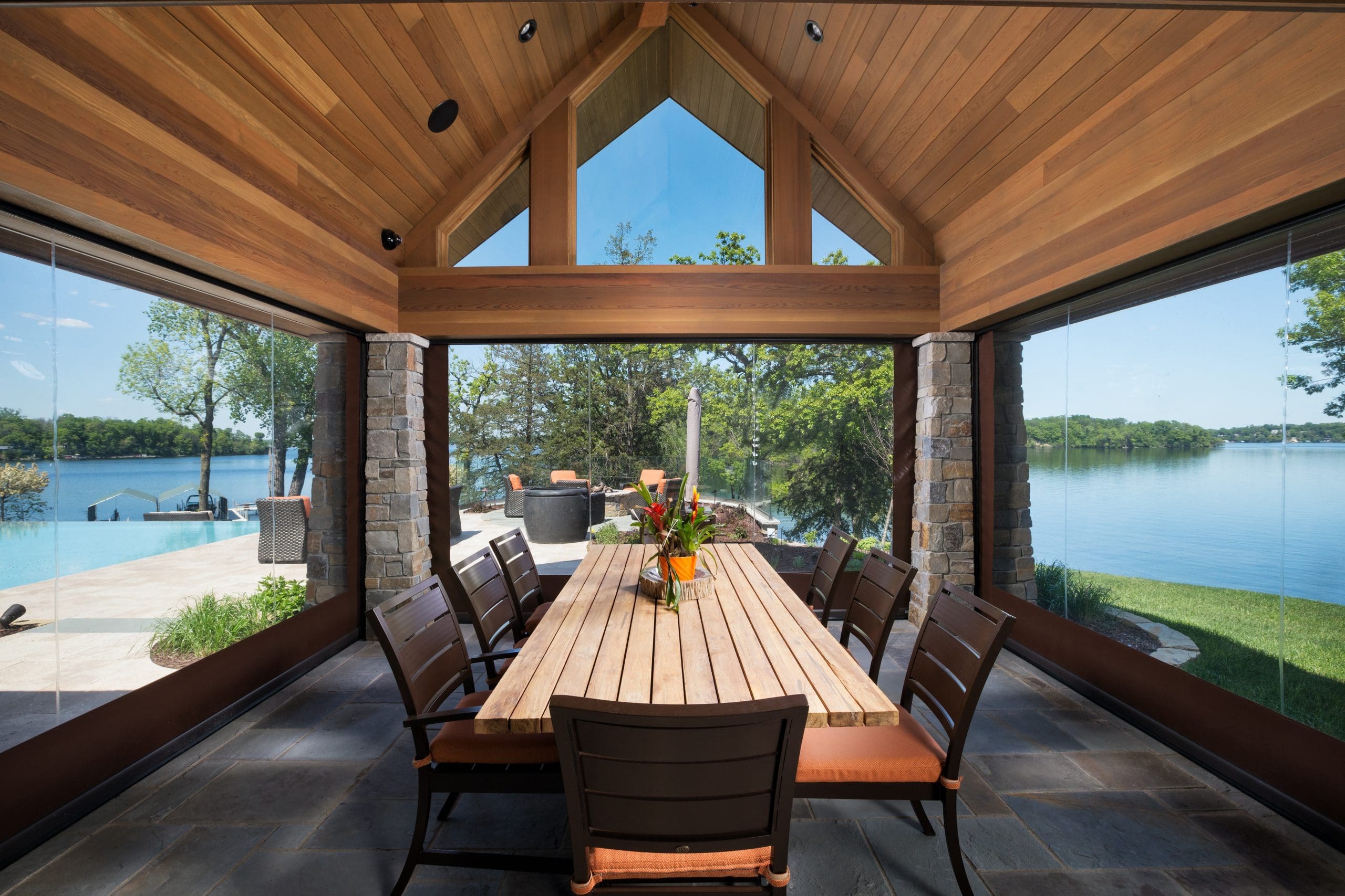 Phantom motorized screening around a covered lakeside dining space