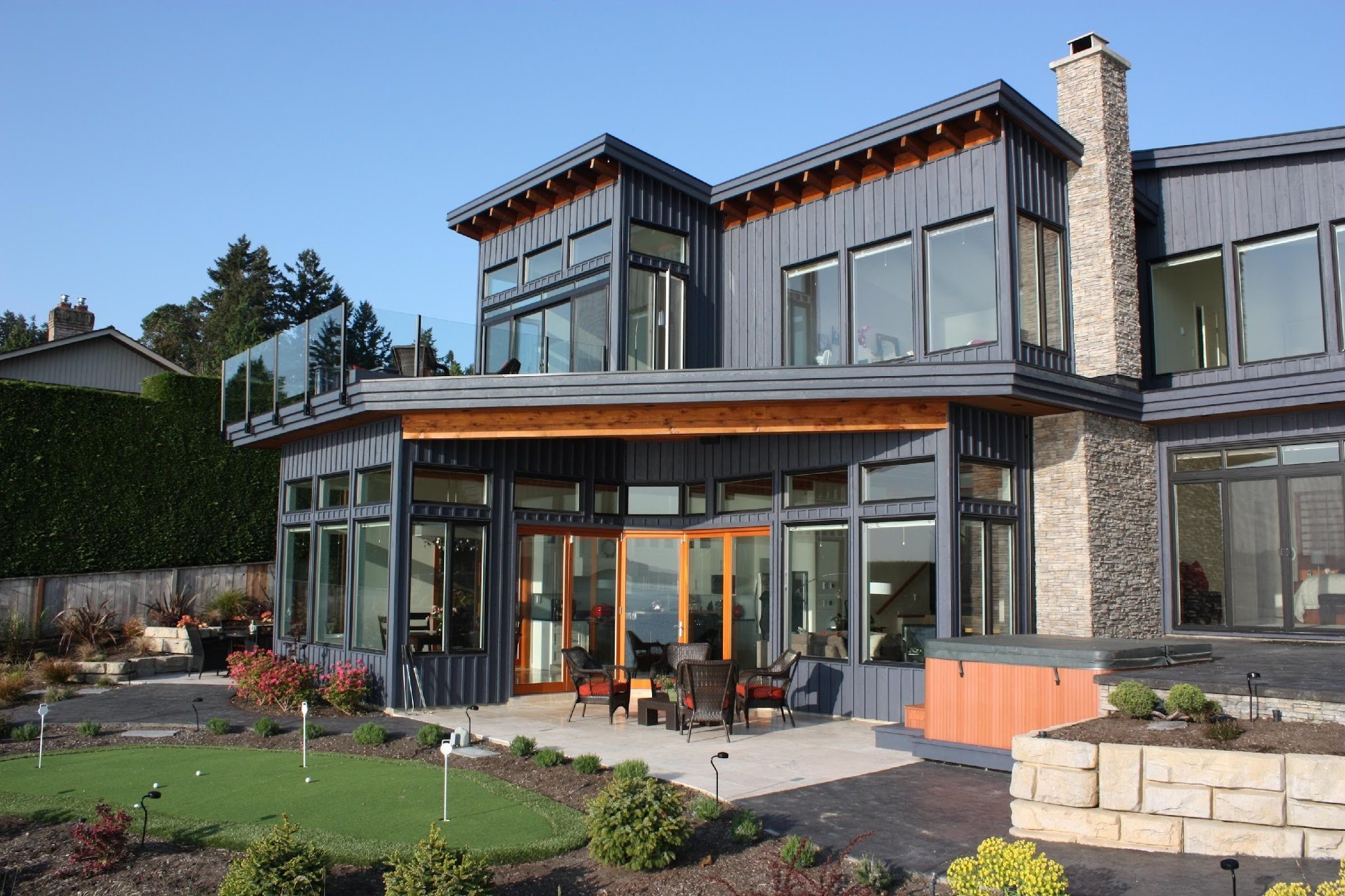 Large windows across a contemporary grey home overlooking a garden